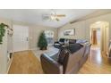 Spacious living room with leather seating and hardwood floors at 59 Pine Dr, Debary, FL 32713