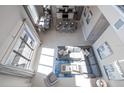 Open living space with gray sectional sofa and kitchen view at 7740 Sandy Ridge Dr # 9-236, Kissimmee, FL 34747