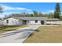 Newly renovated home with a long driveway and carport at 3743 Red Oak Ct, Lake Wales, FL 33898