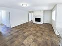 Living room with a stone fireplace and brown tiled floors at 4026 Tenita Dr, Winter Park, FL 32792