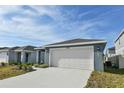 Two-car garage and front entrance of a newly built home at 4815 Rigging St, Haines City, FL 33844