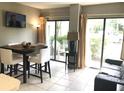 Bright dining area with table and chairs, leads to a patio at 6165 Carrier Dr # 2103, Orlando, FL 32819