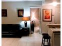 Living room with view into bedroom and kitchen at 6165 Carrier Dr # 2103, Orlando, FL 32819
