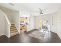 Open living room and kitchen with dark hardwood floors and sliding glass doors at 2020 Retreat View Cir, Sanford, FL 32771