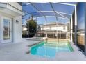 Screened-in pool and jacuzzi with a spacious patio at 1593 Mulligan Blvd, Davenport, FL 33896