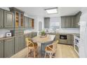 Modern kitchen with gray cabinets, an island, and light wood floors at 3420 Lake Harney Cir, Geneva, FL 32732