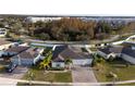 House with solar panels and a large backyard in a residential neighborhood at 402 Blue Lake Cir, Kissimmee, FL 34758