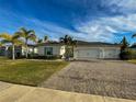Two-story house with a three-car garage and well-manicured lawn at 402 Blue Lake Cir, Kissimmee, FL 34758