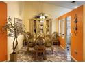 Elegant dining room with glass-top table and ornate chairs at 553 Whittingham Pl, Lake Mary, FL 32746