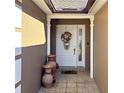 Inviting front entry with decorative pots and wreath at 553 Whittingham Pl, Lake Mary, FL 32746