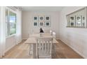 Dining area with light wood table and six chairs, window view at 4807 Khloe Ct, Winter Haven, FL 33884