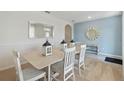 Dining room with light-colored table and chairs, view to living room at 4807 Khloe Ct, Winter Haven, FL 33884