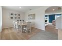 Bright dining room with a light wooden table and six chairs at 4807 Khloe Ct, Winter Haven, FL 33884