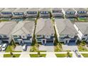 Aerial view of community with multiple two-story houses, pools, and driveways at 6240 Sand Skipper Rd, Orlando, FL 32821
