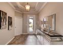 Bright and spacious entryway with tile flooring and a large mirror at 1676 Three Bars Rd, Kissimmee, FL 34744