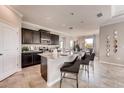Open kitchen with an island, granite countertops, and dark cabinetry at 1676 Three Bars Rd, Kissimmee, FL 34744