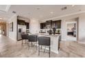 Modern kitchen with dark cabinetry, granite countertops, and stainless steel appliances at 1676 Three Bars Rd, Kissimmee, FL 34744