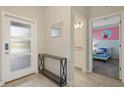 Bright entryway with a console table, leading to a bedroom and bathroom at 820 Pebble Beach Dr, Davenport, FL 33896