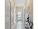 Bright and airy entryway with tile flooring and access to other rooms at 830 Pebble Beach Dr, Davenport, FL 33896