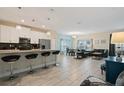 Modern kitchen with stainless steel appliances and an island with seating at 830 Pebble Beach Dr, Davenport, FL 33896