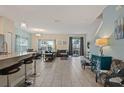 Open concept living space with tile floors and access to kitchen and patio at 830 Pebble Beach Dr, Davenport, FL 33896