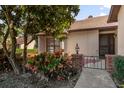 Landscaped entryway with wrought iron gate at 175 Golf Club Dr # 175, Longwood, FL 32779