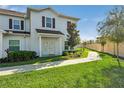 Townhome with walkway, landscaping, and a light-colored exterior at 3212 Cupid Pl, Kissimmee, FL 34747