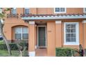 Front entrance of a two-story townhouse with a green door at 7606 Acklins Rd, Kissimmee, FL 34747