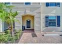 Townhome entry with covered porch and brick walkway at 8891 Geneve Ct, Kissimmee, FL 34747