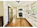 Modern kitchen with white cabinets and stainless steel appliances at 110 Oleander Ave, Auburndale, FL 33823
