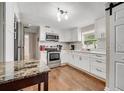 Updated kitchen featuring granite countertops at 110 Oleander Ave, Auburndale, FL 33823
