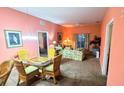 Combined living and dining area with wicker furniture at 210 Watling Way # 24-210, Davenport, FL 33897