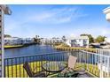 Relaxing balcony with lake view, featuring a table and chairs at 2516 Woodgate Blvd # 206, Orlando, FL 32822