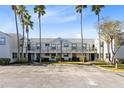 Exterior view of the building, showcasing the parking lot and landscaping at 2516 Woodgate Blvd # 206, Orlando, FL 32822