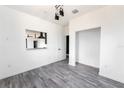 Bright dining area with kitchen pass-through and wood-look flooring at 326 Spinnaker Ct, Auburndale, FL 33823