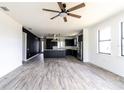 Spacious living room with modern flooring and a ceiling fan at 326 Spinnaker Ct, Auburndale, FL 33823