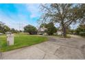 Two-story house with a large yard, circular driveway, and mature trees at 2351 Westwood Dr, Longwood, FL 32779