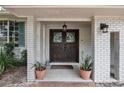 Inviting entryway with double doors, stained glass, and potted plants at 2351 Westwood Dr, Longwood, FL 32779