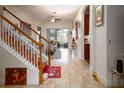 Bright entryway with wooden staircase and view into living room at 2814 Plymouth Pl, Kissimmee, FL 34741