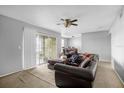Spacious living room with a large sectional sofa and access to a patio at 3954 Versailles Dr # 3954B, Orlando, FL 32808