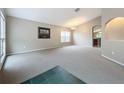 Spacious living room with neutral carpeting and a vaulted ceiling at 425 Tree Shore Dr, Orlando, FL 32825