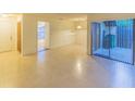 Spacious living area with tile floors and sliding glass doors to a patio at 547 Hunter Cir # 547, Kissimmee, FL 34758