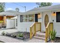 Renovated home featuring a wooden staircase and landscaping at 830 Overspin Dr, Winter Park, FL 32789