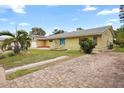 Ranch style home with brick paver driveway and palm trees at 10637 Deergrass Ln, Orlando, FL 32821