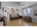 Bright living room featuring hardwood floors, a brown couch, and large artwork at 15 Volusia Dr, Debary, FL 32713