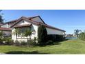 Two story house with tile roof, water view, and manicured landscaping at 15511 Shorebird Ln, Winter Garden, FL 34787