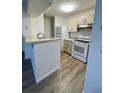 Bright kitchen featuring modern appliances and wood-look floors at 315 Lakepointe Dr # 302, Altamonte Springs, FL 32701