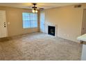 Living room with carpeted floors, fireplace, and ceiling fan at 485 Forestway Cir # 202, Altamonte Springs, FL 32701