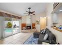 Living room with pool view, fireplace, and gray sectional sofa at 5027 Jamaica Cir # 7, Orlando, FL 32808
