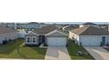Two-story house with gray siding and a two-car garage at 1224 Golden Eagle Ln, Winter Haven, FL 33880